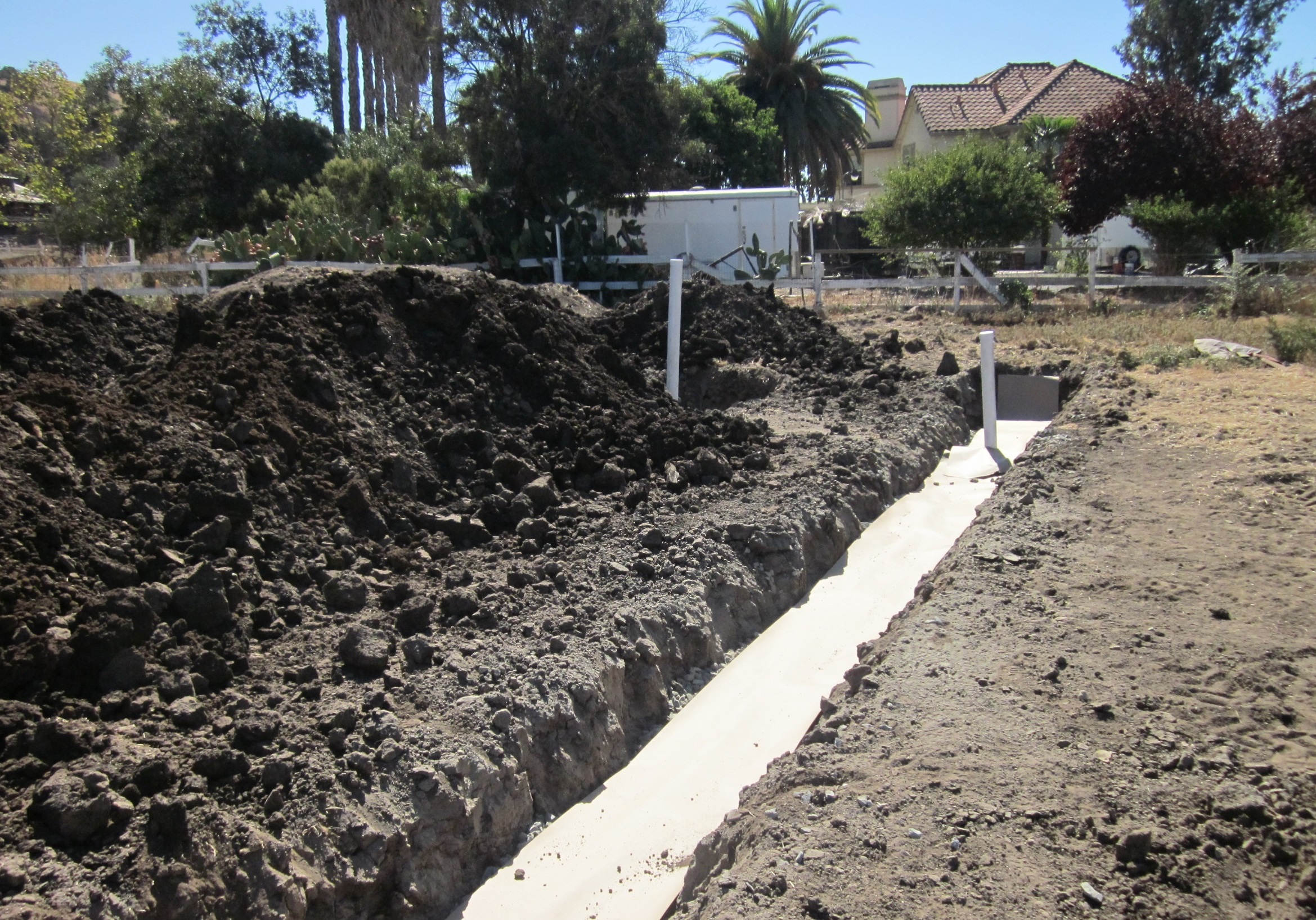 Image of a property with a septic treatment system being installed in the backyard.